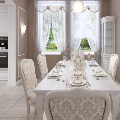 Eine helle Küche im klassischen Stil in Weiss mit transparenten Gardinen, Raffhaltern sowie mit Bögen.